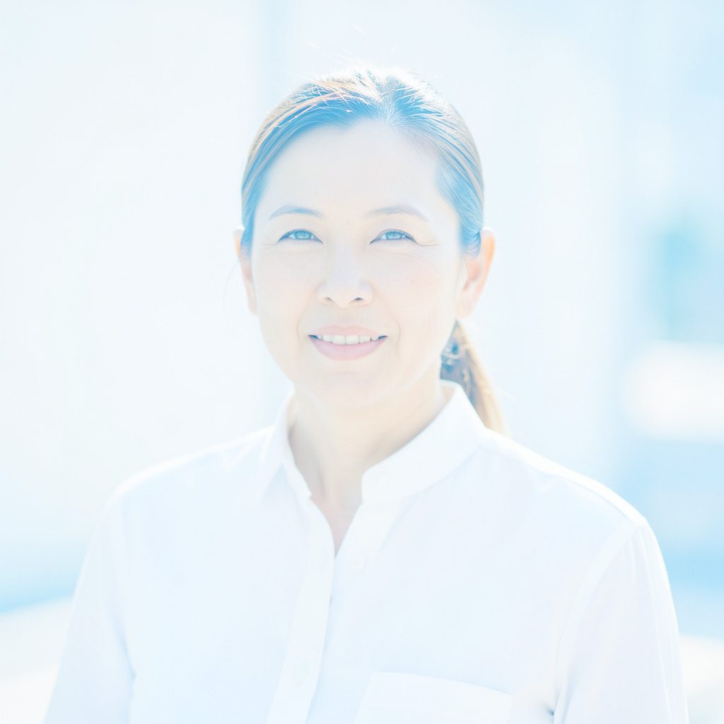 A clear, well-lit portrait-style photo with a calm, professional mood in soft blue and neutral tones